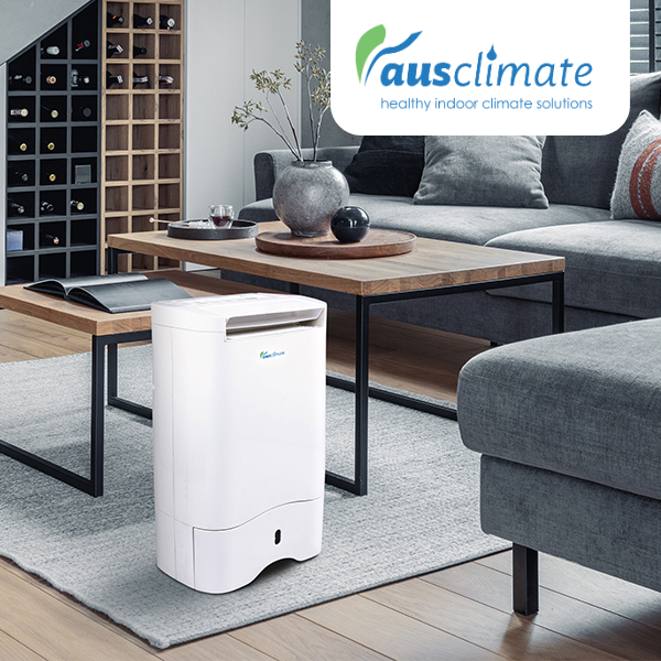 an air purifier in the middle of a room, with couches around it.